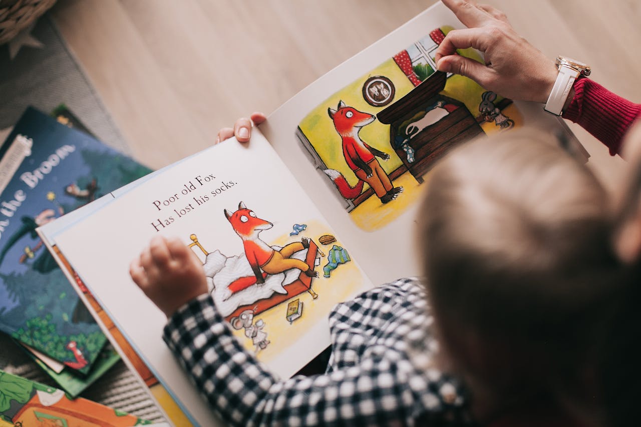 embark A child and adult reading an illustrated storybook together in a cozy setting.
